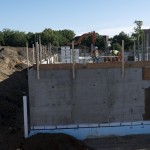 Crew members work atop basement walls - June 2016